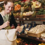 Woman putting pineapple bag